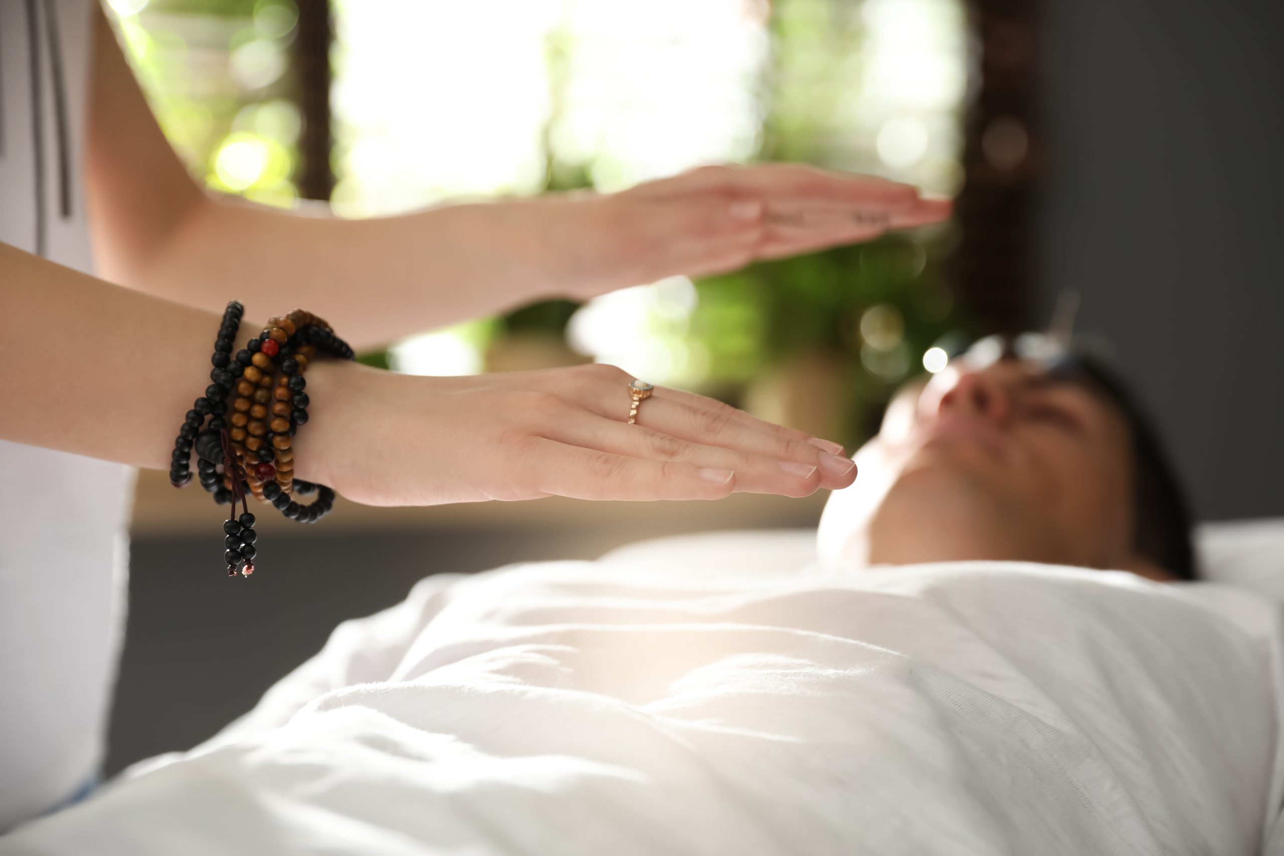 Woman performing Reiki on man