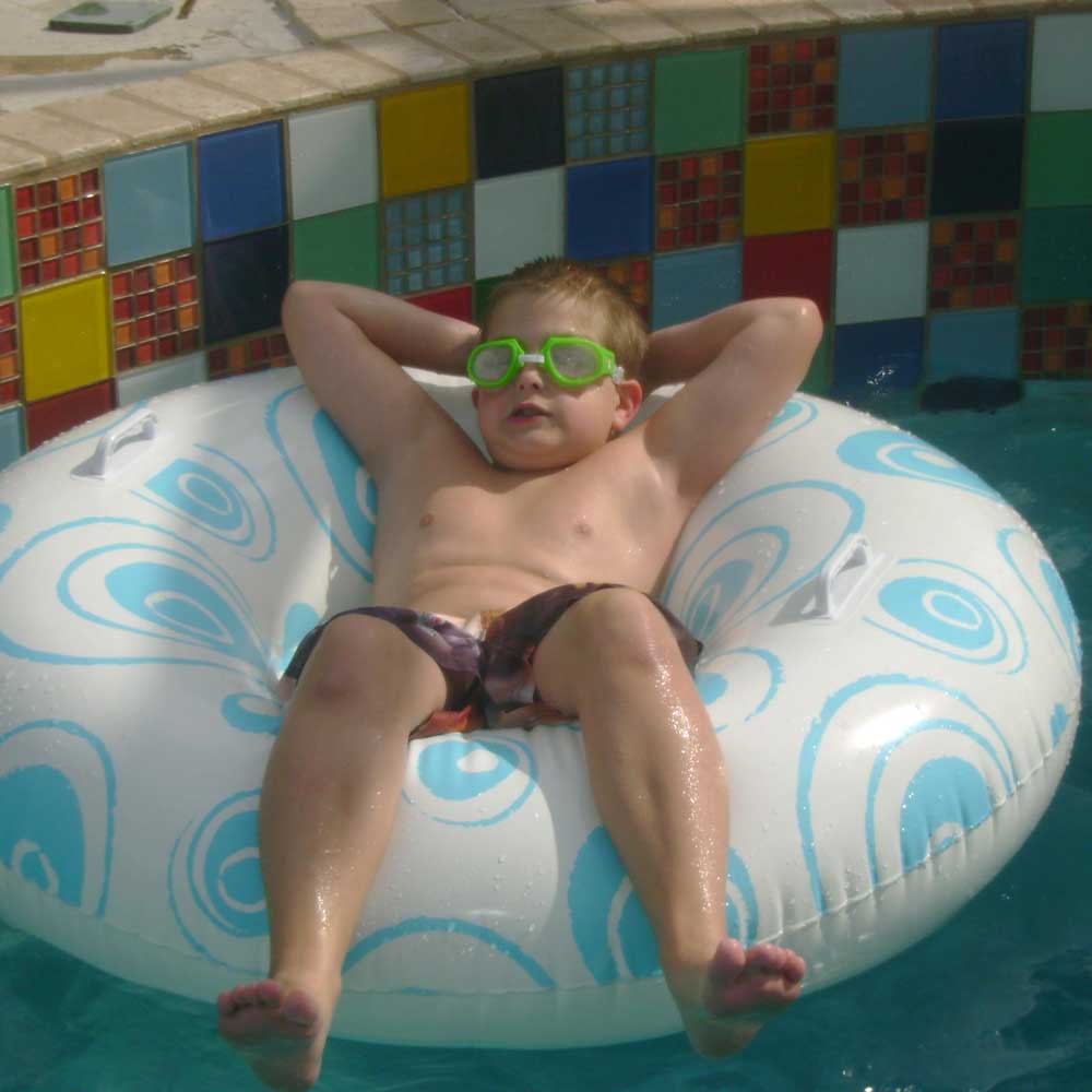 Child on inter tube in pool